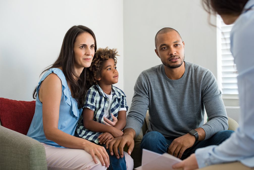 Multiracial couple consulting with loan officer