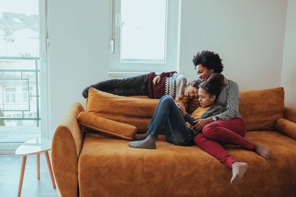 Black family spending time together on a sofa