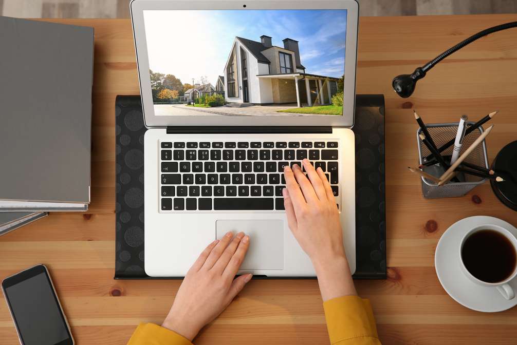 Home buyer looking through online property portfolio, top view